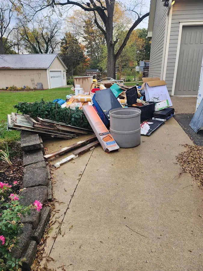 Dumpster being loaded with debris for Roofing Dumpster Rental in Wynne